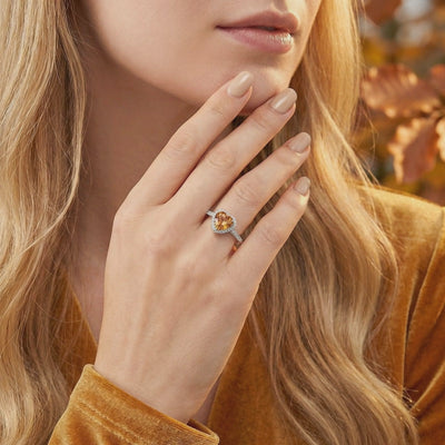 Heart-cut simulated topaz halo ring in solid white gold.