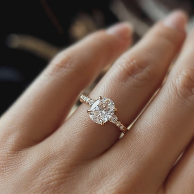A ring with a 2 carat oval moissanite and solid gold material