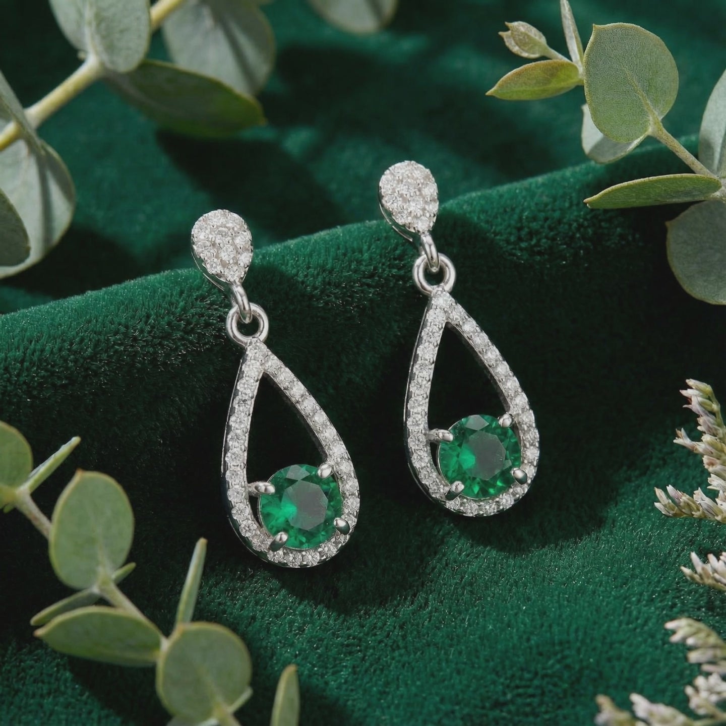 Simulated emerald drop earrings in solid gold.