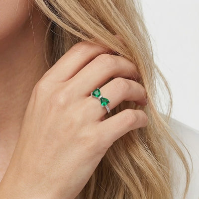 Solid gold ring with simulated emeralds.