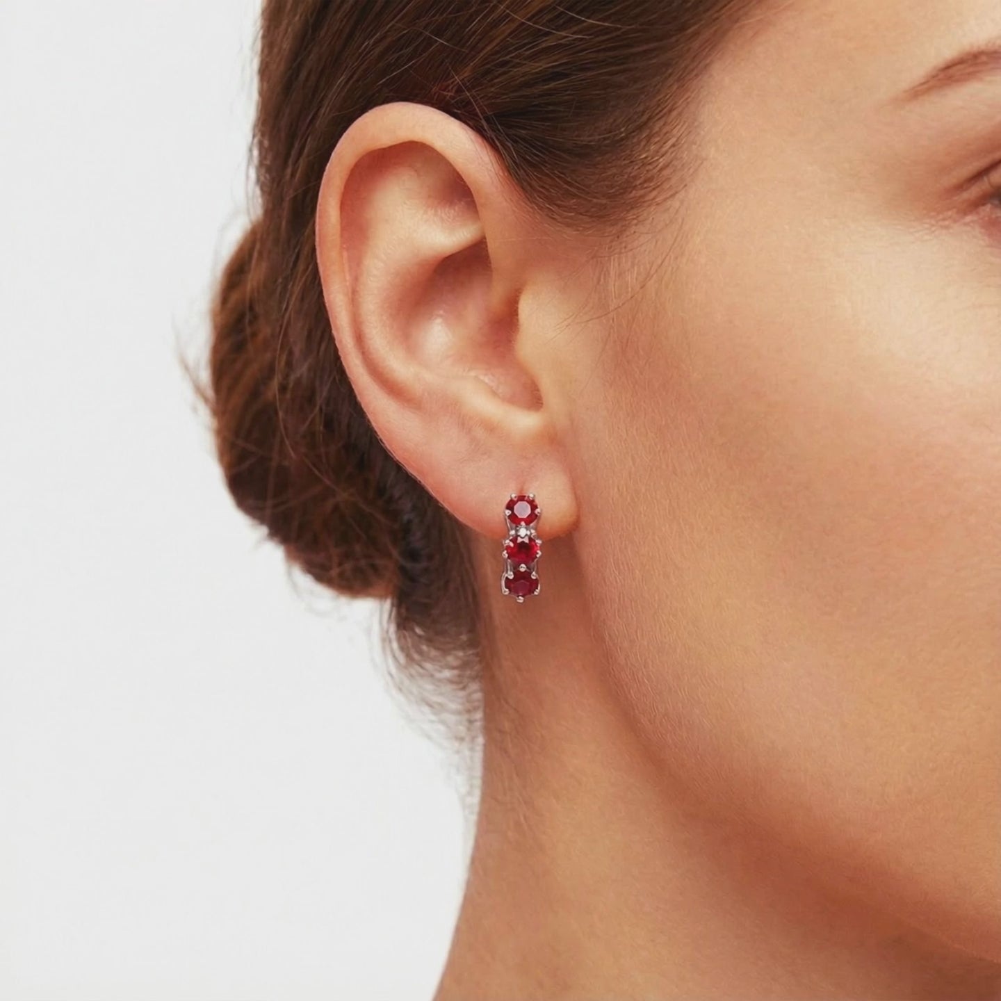 Star-cut simulated ruby huggie earrings in solid gold.