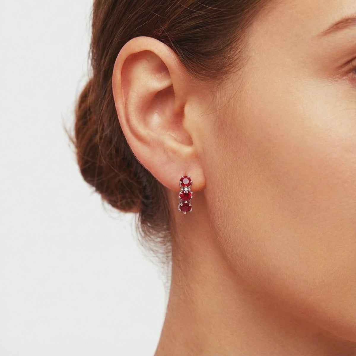Star-cut simulated ruby huggie hoop earrings in solid gold.