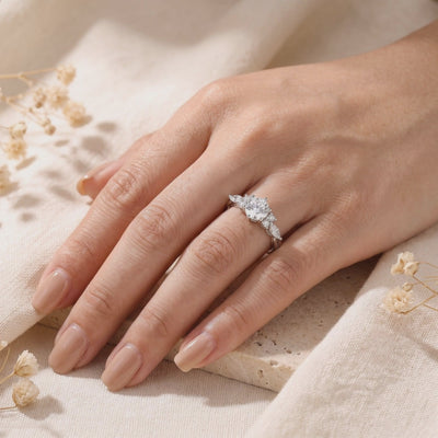 Claraluna silver ring with a round center stone worn on a hand against a soft linen background.