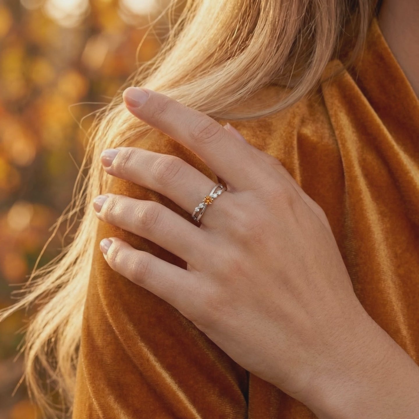 Solid white gold crossover ring featuring a simulated topaz.