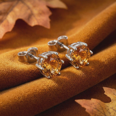 Video of solid gold stud earrings with simulated topaz.