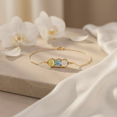 The Adelaide solid gold bracelet with a three-peas-in-a-pod bezel setting.