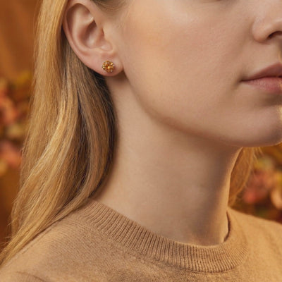 Video of solid gold stud earrings with simulated topaz.