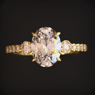 A ring with a 2 carat oval moissanite and solid gold material