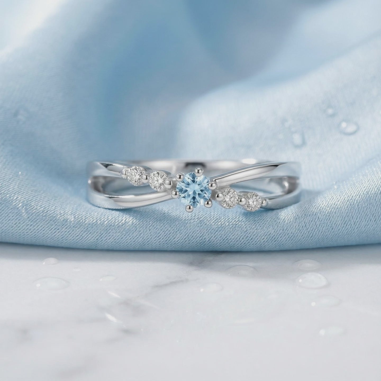 A solid gold ring with a simulated aquamarine.