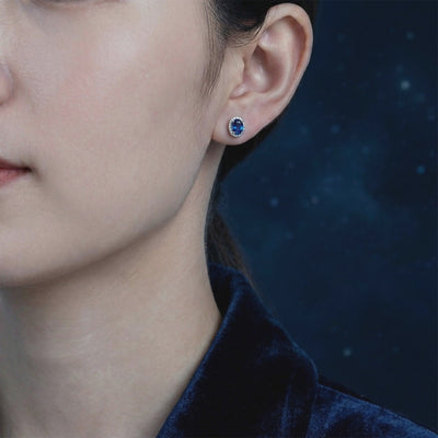 Simulated sapphire halo stud earrings in solid gold.