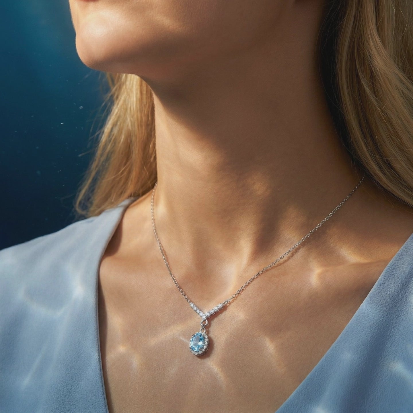Aquamarine oval halo necklace in solid gold.