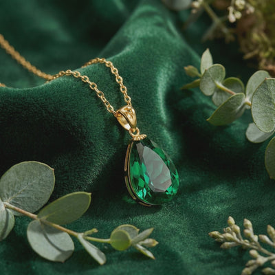 Solid gold necklace with pear-cut simulated emerald.