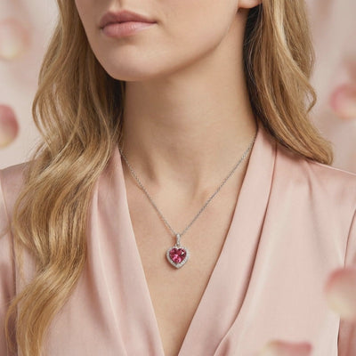 A solid gold necklace with a heart-cut simulated pink tourmaline pendant.