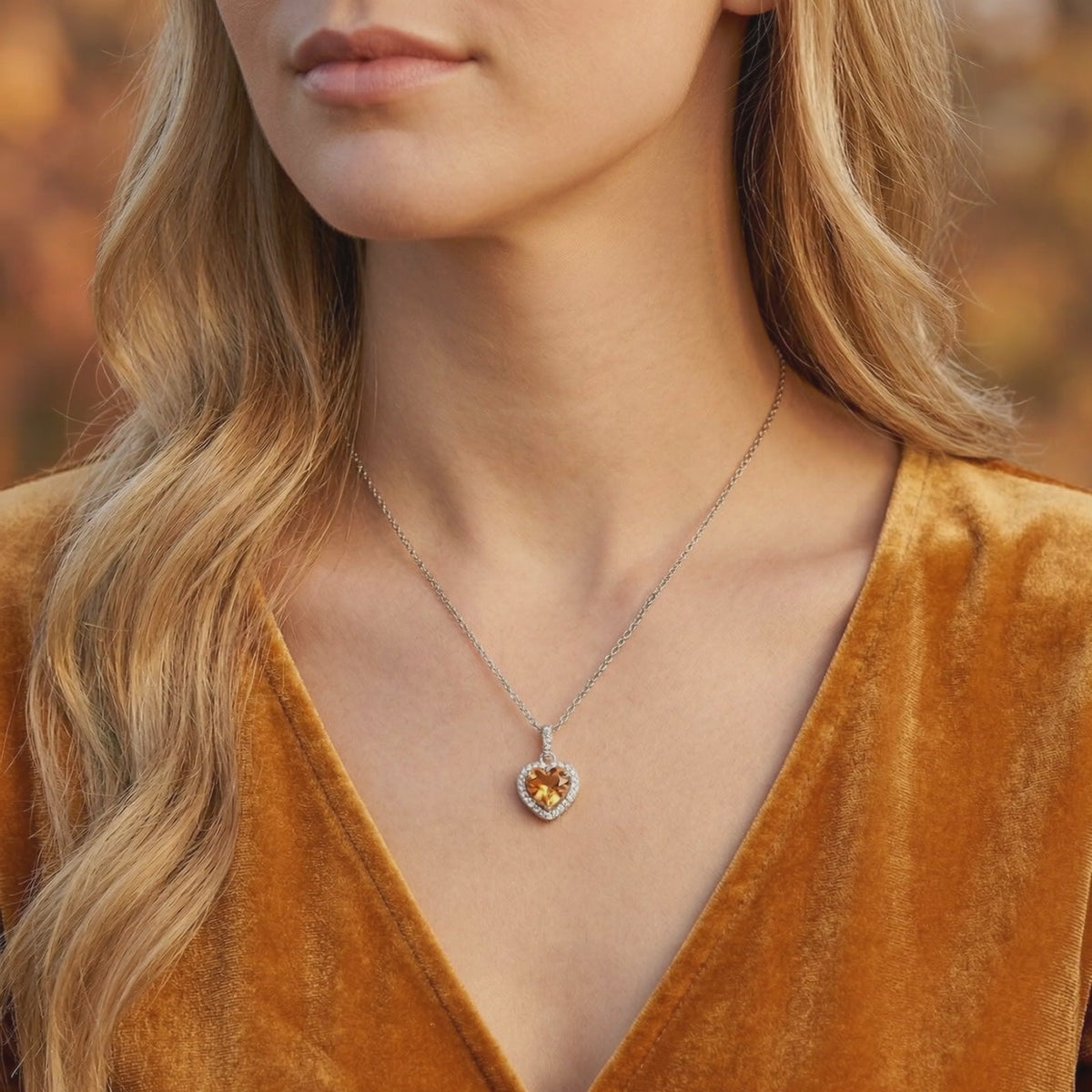 Solid gold necklace featuring a heart-cut simulated topaz pendant.