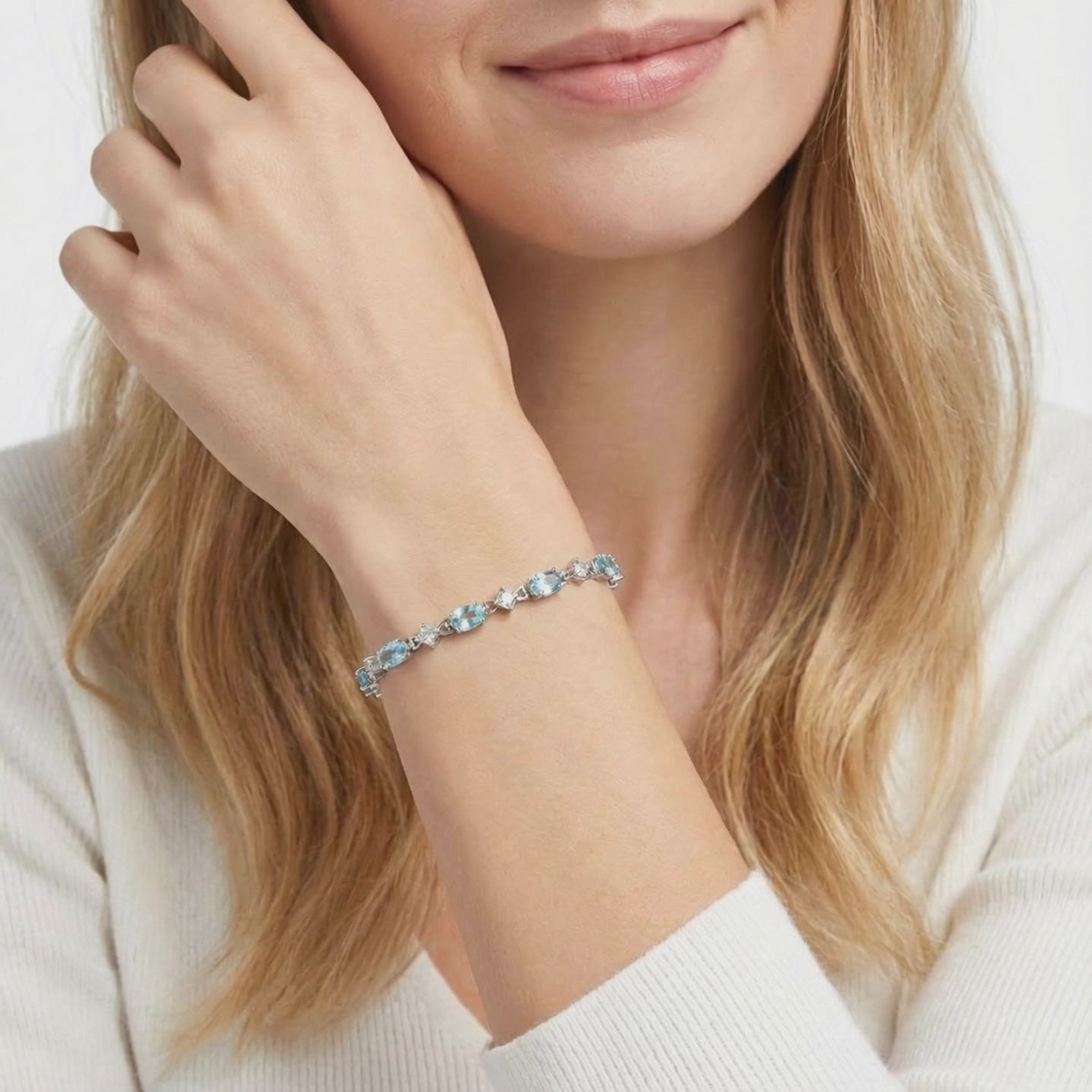 Coralia station bracelet with simulated aquamarine stones in solid gold.
