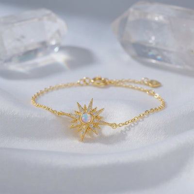 A solid gold tennis bracelet with natural white opals, highlighting the play-of-color.