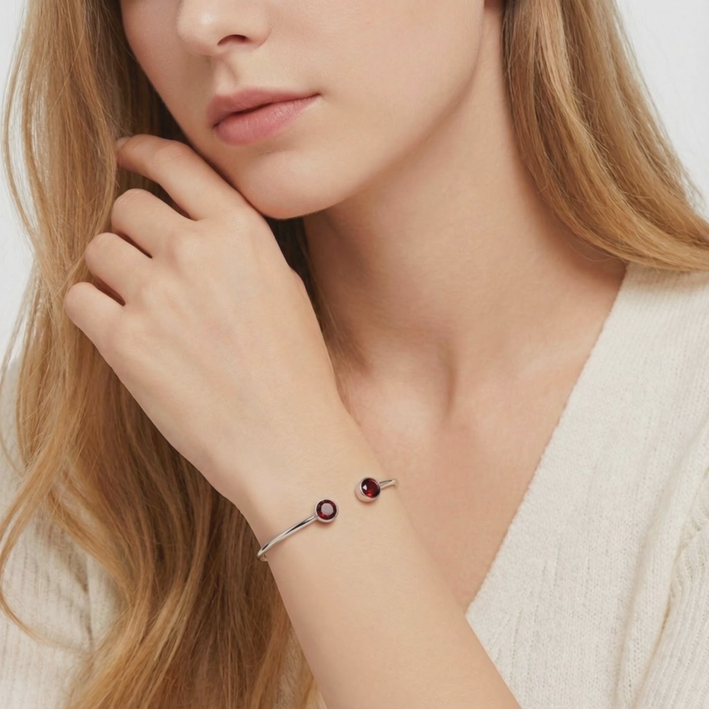 Solid gold cuff bracelet with simulated garnets.