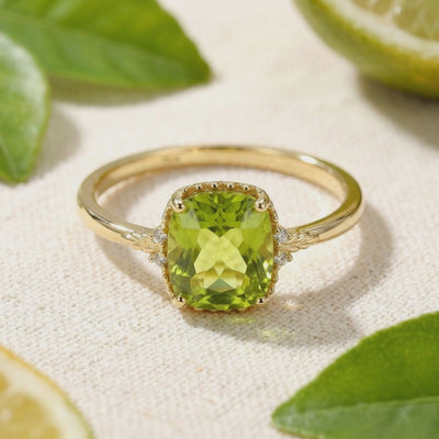 A solid gold ring with a simulated peridot stone.