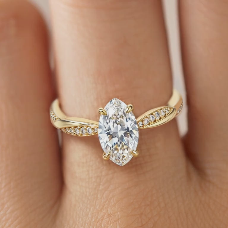 Video of the 1CT marquise cut moissanite ring with a twisted band in solid gold.