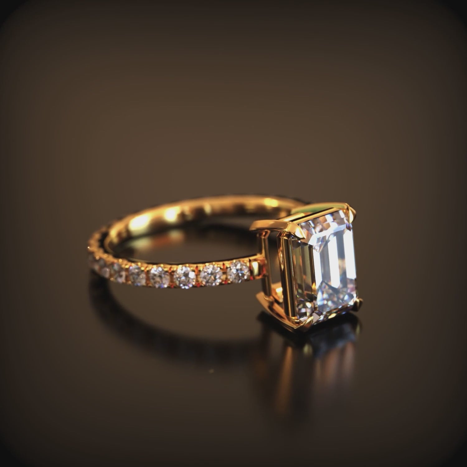 A solid gold ring with a 2CT emerald-cut moissanite gemstone.