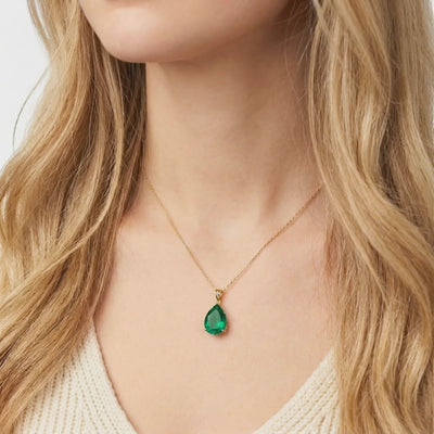 Solid gold necklace with pear-cut simulated emerald.