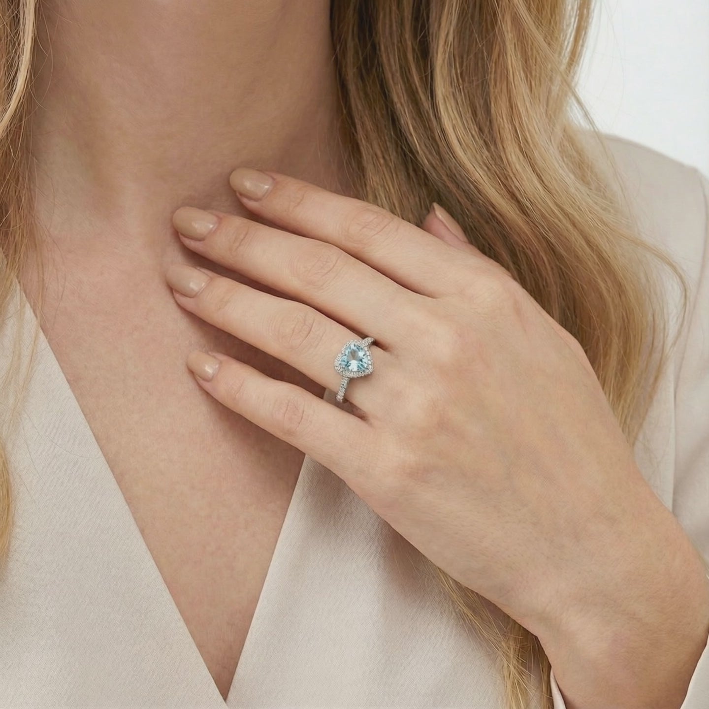 Simulated aquamarine heart halo ring in solid gold.