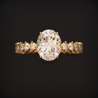 A ring with a 2 carat oval moissanite center stone and a gold eternity band.