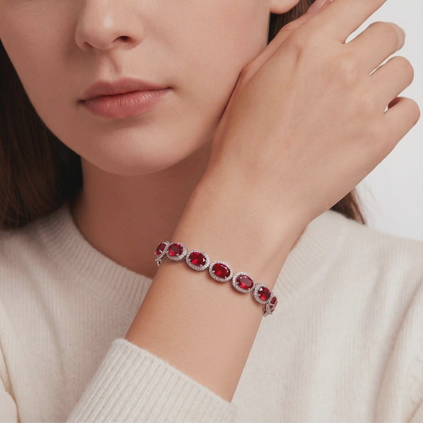Solid gold tennis bracelet with simulated rubies.