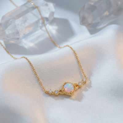 Solid gold necklace with a natural white opal column pendant.