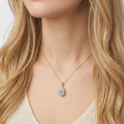 A solid gold necklace with a pear-cut A5 Zirconia pendant.