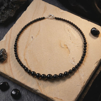 A necklace with natural black onyx beads in solid gold.