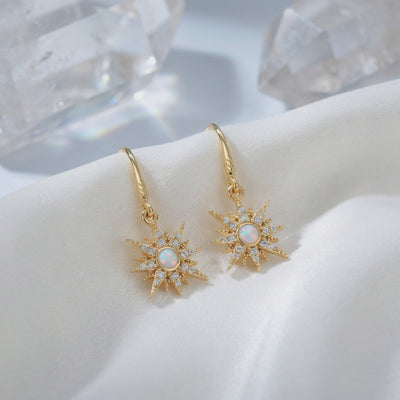 Solid gold opal starburst drop earrings.
