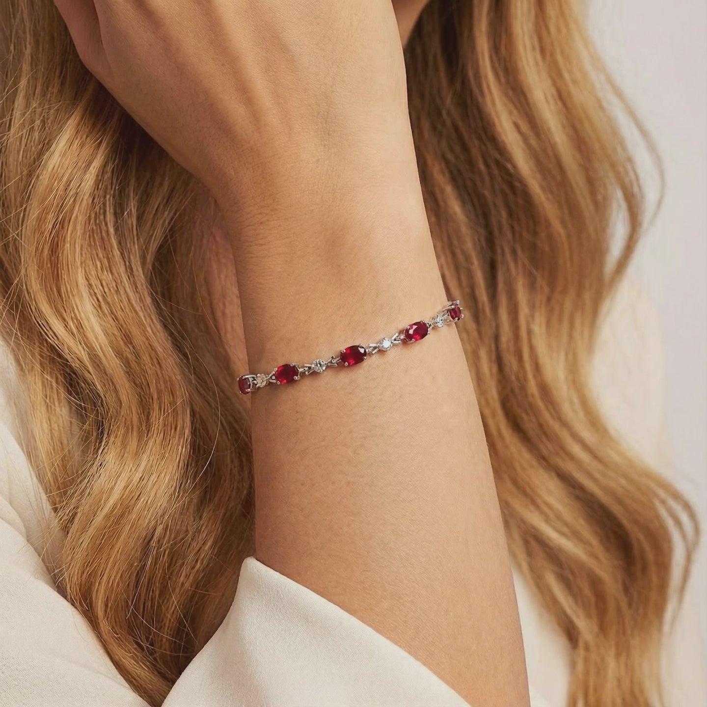 The Vivara Oval Simulated Ruby Tennis Bracelet in solid gold.