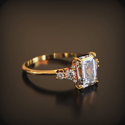A ring with a 3 carat emerald-cut moissanite in solid gold.