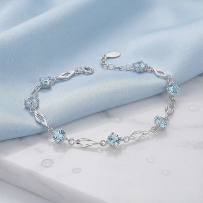 Solid gold bracelet with simulated aquamarine stones.