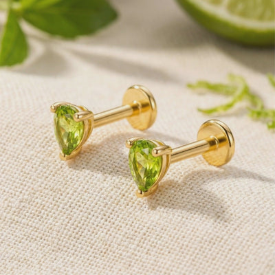 A pair of solid gold earrings with simulated peridot.
