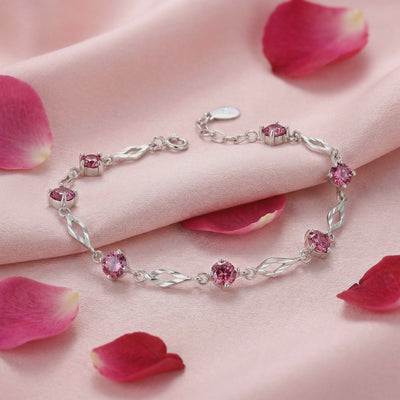 Solid gold bracelet with simulated pink tourmaline stones.