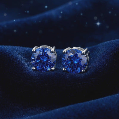 Royal blue simulated sapphire stud earrings in solid gold.