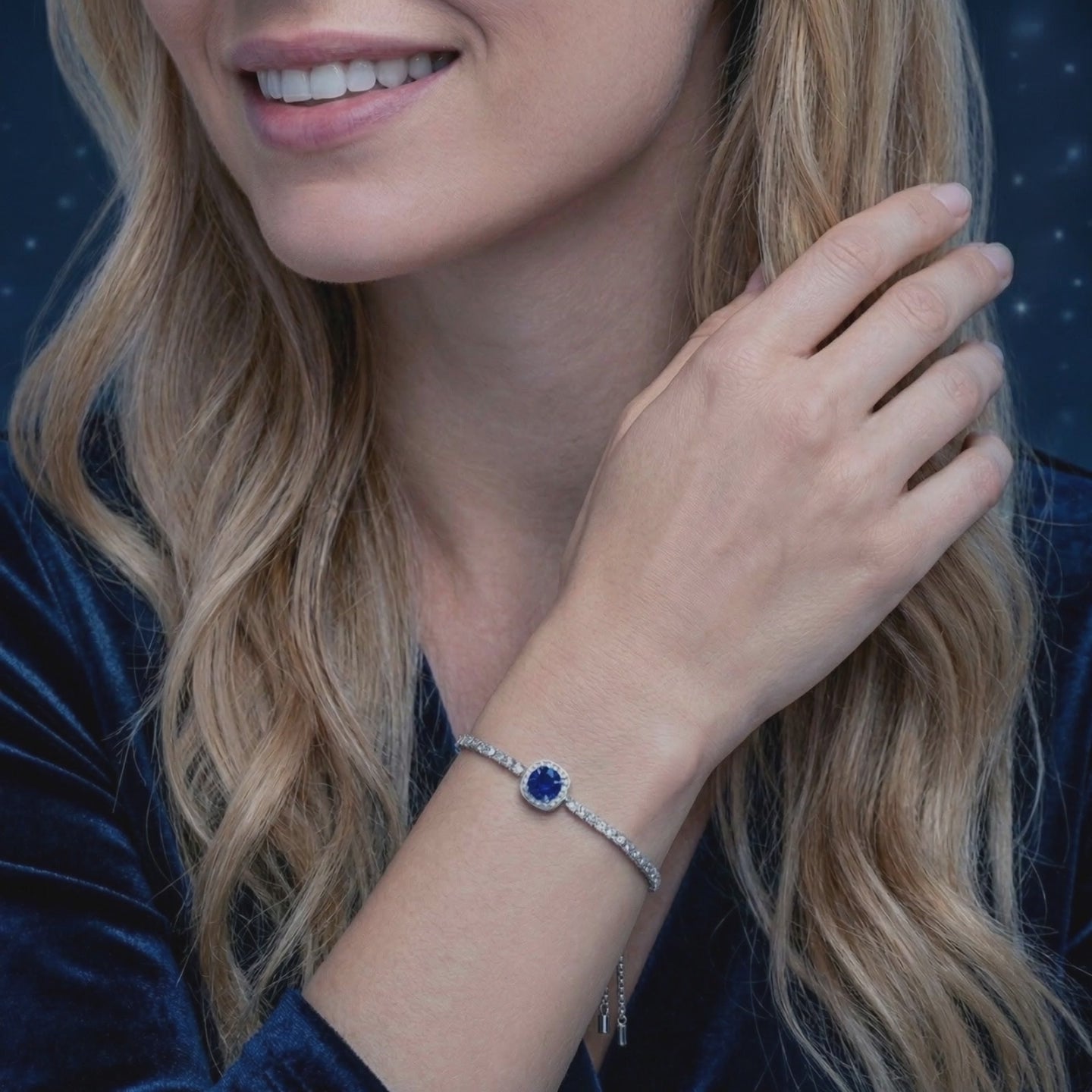 A solid gold bracelet with a simulated sapphire.