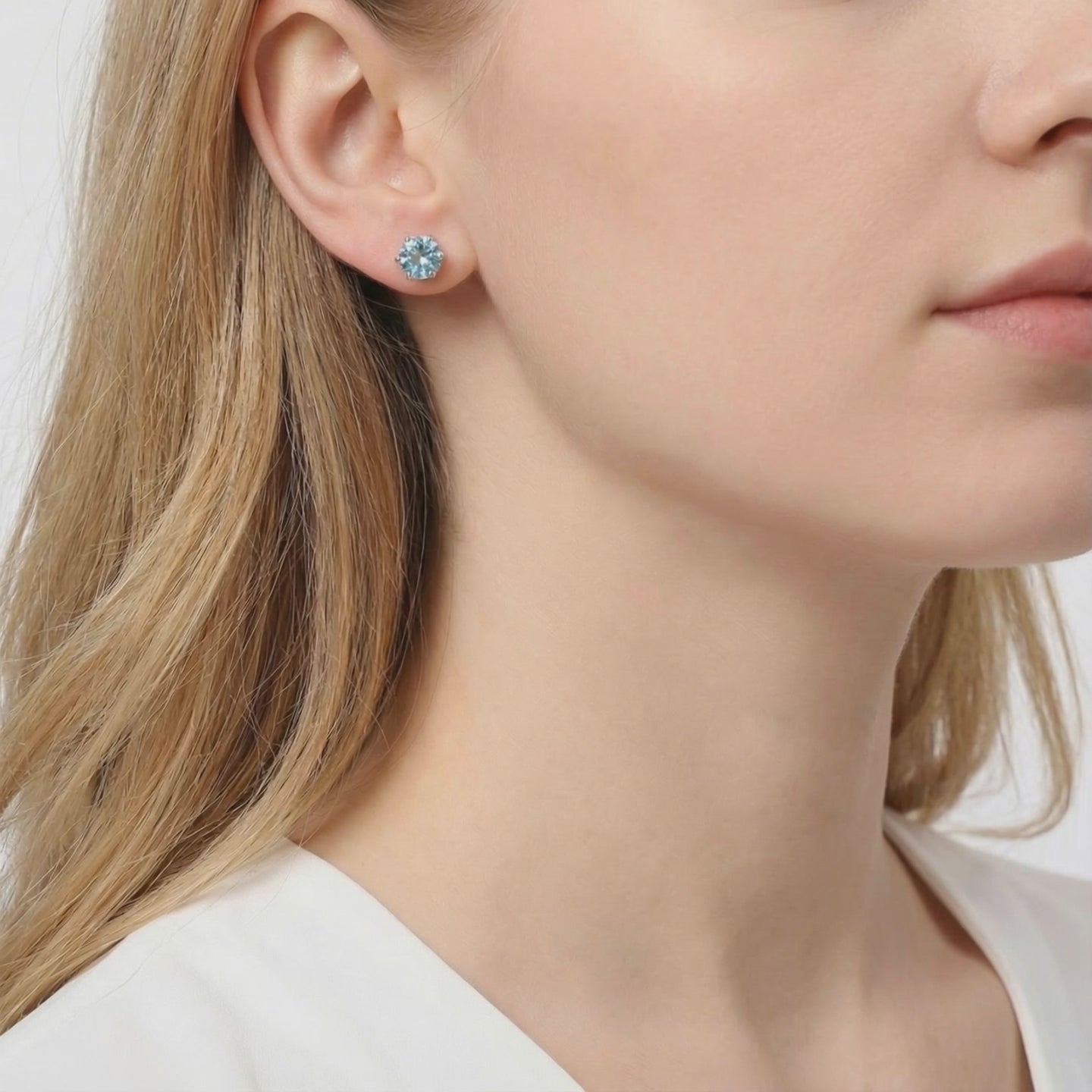 Simulated aquamarine stud earrings in solid gold.