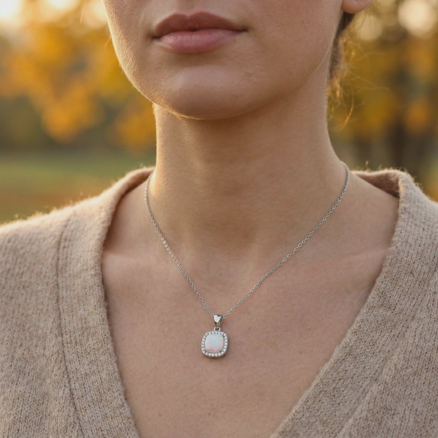 A solid gold cushion opal pendant necklace.
