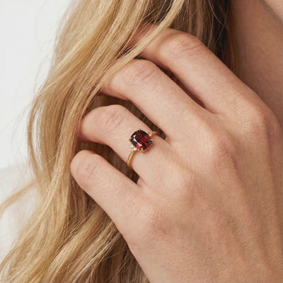 Valerine solid gold ring with simulated garnet.