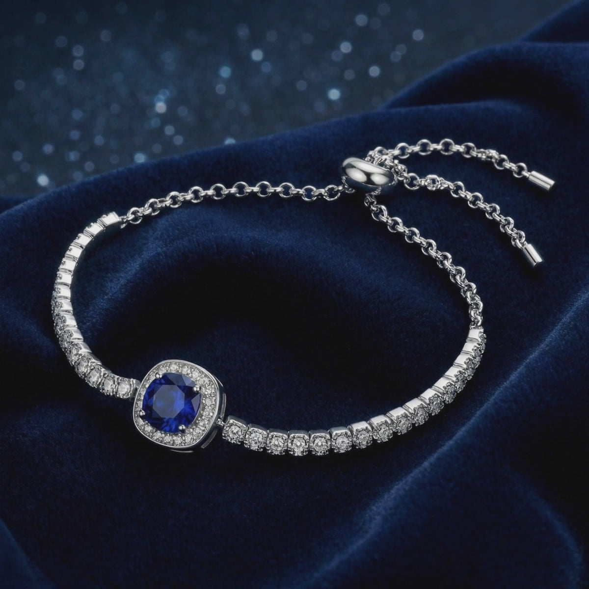 A solid gold bracelet with a simulated sapphire.