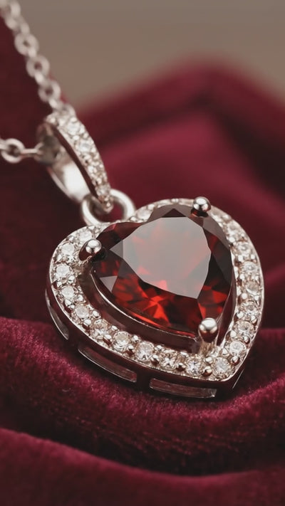 A heart-cut simulated garnet solid gold necklace.
