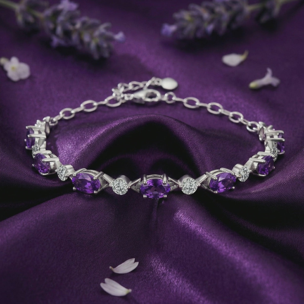 A solid gold station bracelet with natural amethyst and simulated diamond accents.