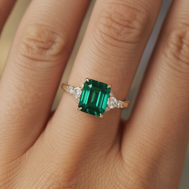 A green moissanite ring in solid gold.