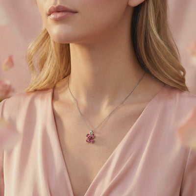Solid gold necklace with simulated pink tourmaline flower pendant.