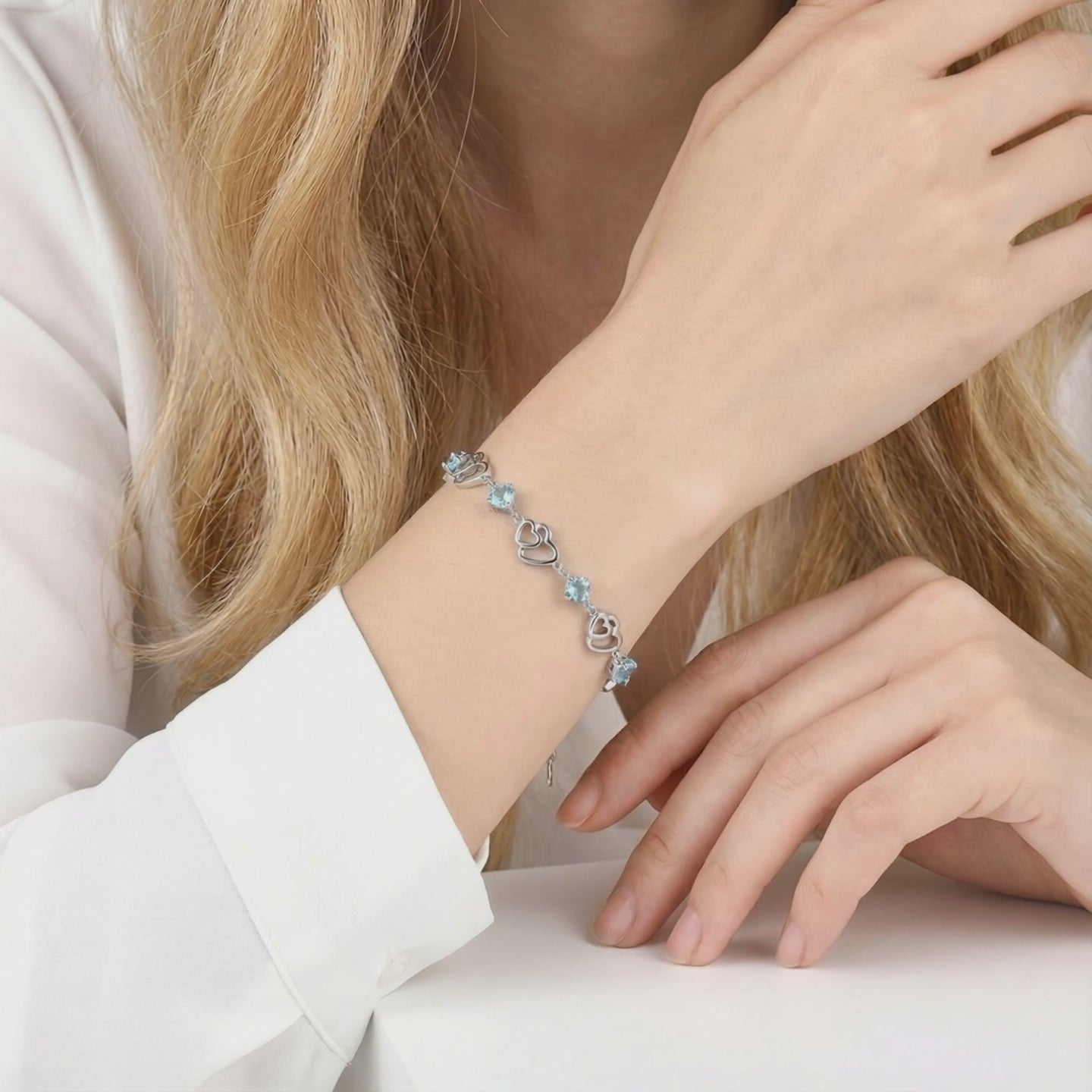 A solid gold bracelet with simulated aquamarine stones.