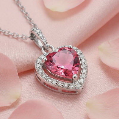 A solid gold necklace with a heart-cut simulated pink tourmaline pendant.