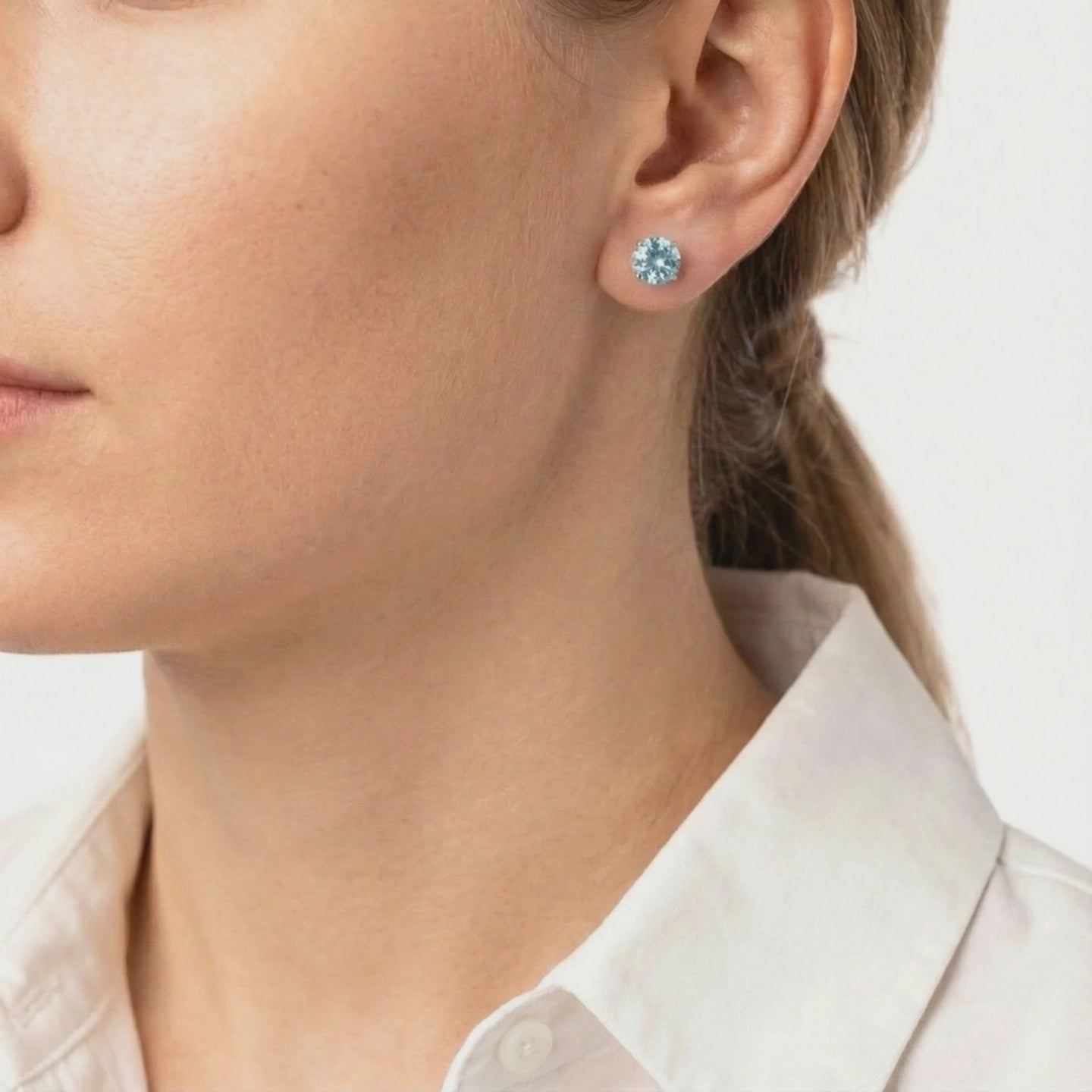 Simulated aquamarine stud earrings in solid gold.